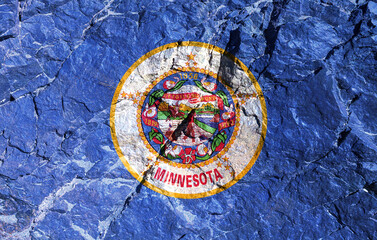 National flag of the American state of Minnesota in a round shape on a blue background painted on a mountain wall on Independence Day. Rock graffiti of climbers during the ascent.