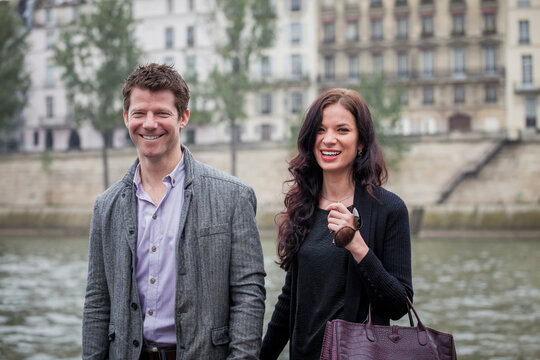 Smiling couple on the banks of the Seine River