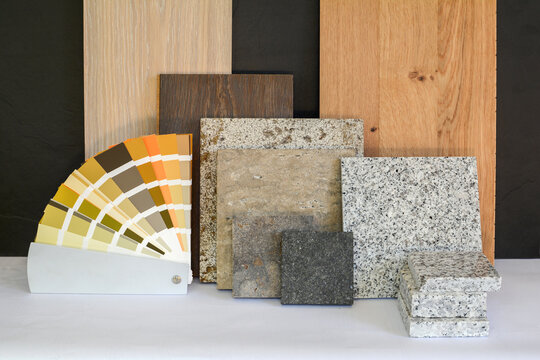 Material collage with natural stone, tiles, wooden parquet floor and color card for renovation of an apartment building
