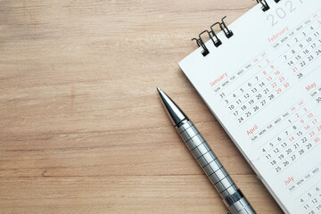 top view of calendar and pen on table with copy space 