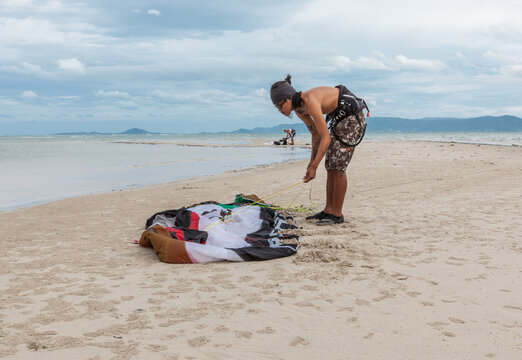 Surfer Preparing His Kite at the Beach