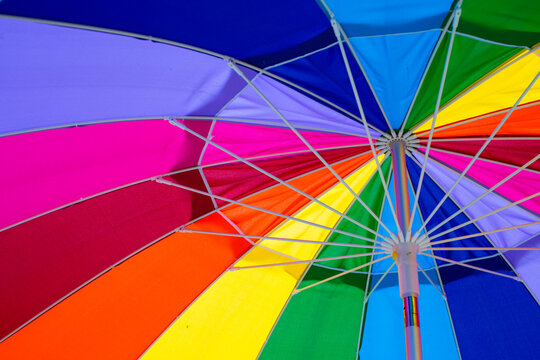 Closeup image of a rainbow coloured umbrella
