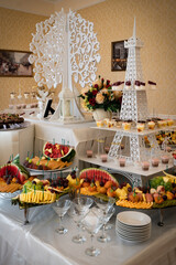 Wedding sweets, decorated tables, decorations and cupcakes, delicious meat and delicacies