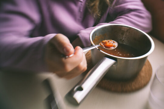 Woman Eating Food From a Pot