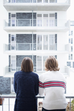 Berlin couple on balcony.