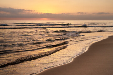 sunrise on the beach with the sea calm
