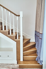 Winder steps of a wooden staircase with built-in wardrobe
