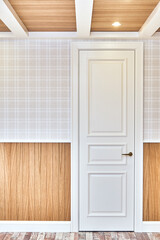 Classic style white door in a room with wooden slats wall and ceiling