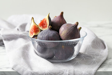 Whole and cut tasty fresh figs on table