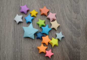 Colored lucky origami stars on wooden background