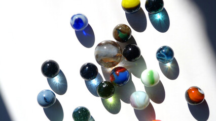 Light Reflecting in Colorful Glass Marbles on a White Surface