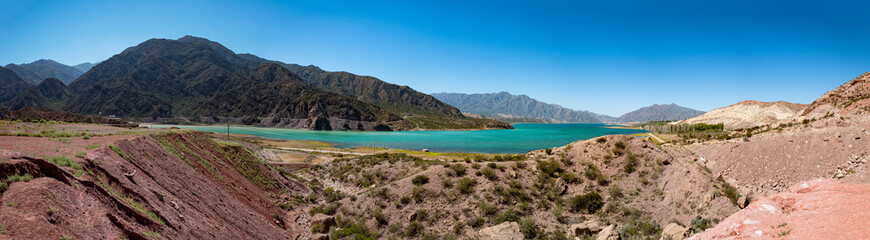 Panoramic view of a big lake in front of Los Andes Mountains
