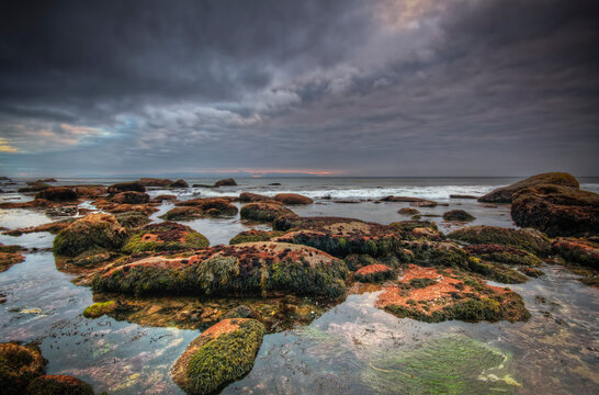 Gray cloud ocean rocks