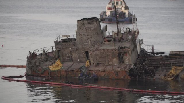 Industrial ship crane lifts old sunken tanker Delfi from Black Sea in Odessa, Ukraine 26 August 2020. Ship crashed near shore sea. Cargo tanker. Ecological disaster oil spill products. Tanker Delphi