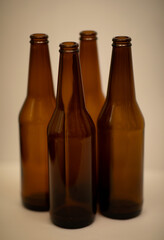 Four dark empty beer bottles.