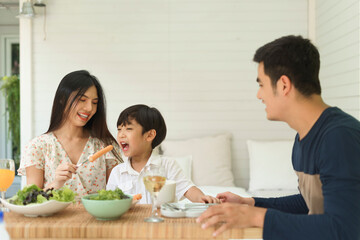 Happy family having lunch or breakfast together at home