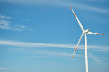 Blue sky wind turbine. Nature and eco-friendly energy.
