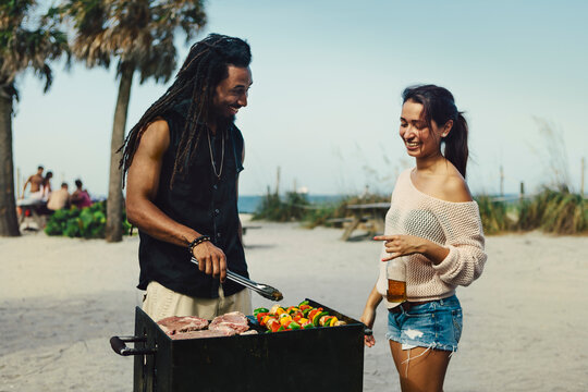 Man and Woman Grilling at the Beach