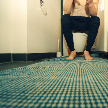 Man sitting on toilet