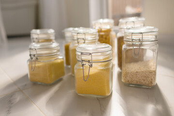 Collection of grain productsin storage jars over on kitchen. Jar of cereals in kitchen cupboard
