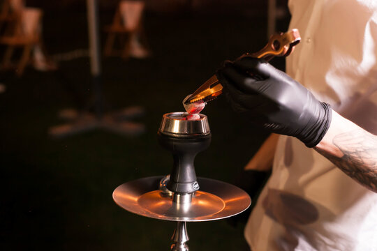 evening men's hands hookah a lot of smoke