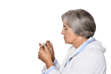 Ill beautiful senior woman with thermometer isolated 