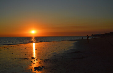 Fototapeta premium Red sunset on the beach of Punta Candor, Rota Costa de la Luz Cadiz, Spain