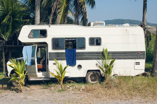 Camper parked under palmtrees.