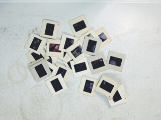 Vintage 35mm film slides on an old white table