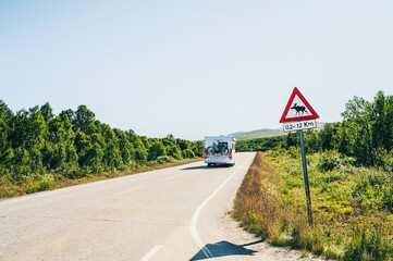 Caravan on Highway with a Moose Warning Sign in Norway, Scandinavia