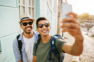 Two happy male tourists taking self portrait. Travel and love concept in Latin America