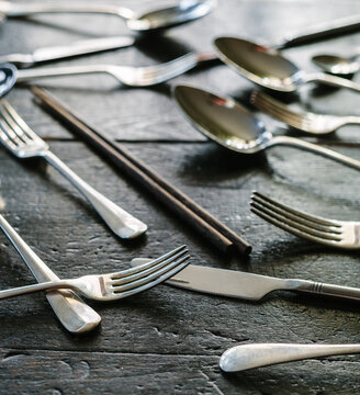 Cutlery strewn across a table.
