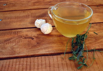 Green tea with mint in a transparent cup and white chocolates.
