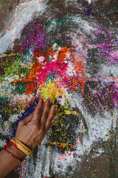 Mother of groom collects the Rangoli during Mayian ceremony of Sikh wedding