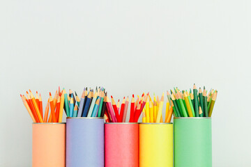 bright colored pencils in matching containters
