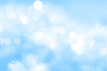 Obraz premium Bokeh light on blue background, sky with circle glitter light blue. Snow abstract soft glowing with vivid bright light and bokeh blur effect. 