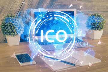 Double exposure of blockchain theme hologram and table with computer background. Concept of bitcoin crypto currency.