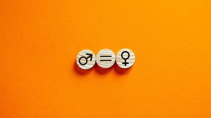 Gender equality conceptual image. Male and female symbol on wooden circles on beautiful orange background. Copy space. - obrazy, fototapety, plakaty