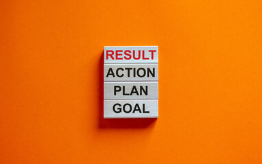 Wooden blocks form the words 'goal, plan, action, result' on beautiful orange background. Business...