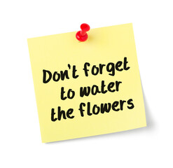 Yellow paper note with text Dont forget to water the flowers