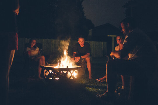 Authentic Conversation Among Friends Around Backyard Campfire