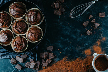 A lots of chocolate muffins on black background, free space for text