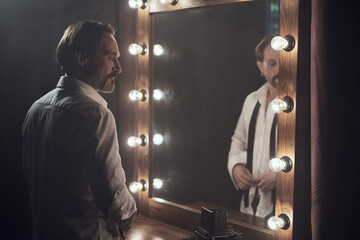 cinematic photo shoot of the confident actor celebrity look in foggy loft room