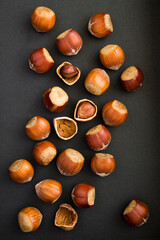 Top view of hazelnuts on the black background. Location vertical.