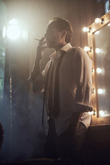 cinematic photo shoot of the confident actor celebrity look in foggy loft room