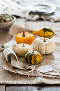 some small pumpkins placed on napkins