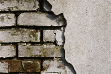 Background old brick wall with cracked and crumbling plaster, the image display as a frame, you can place any text or image.