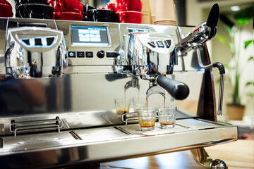 Coffee machine brewing fresh espresso into glass