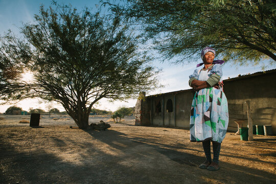 Proud Nama woman standing outside her home