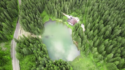 Beautiful Chalet along the lake in a wonderful mountain forest, aerial view